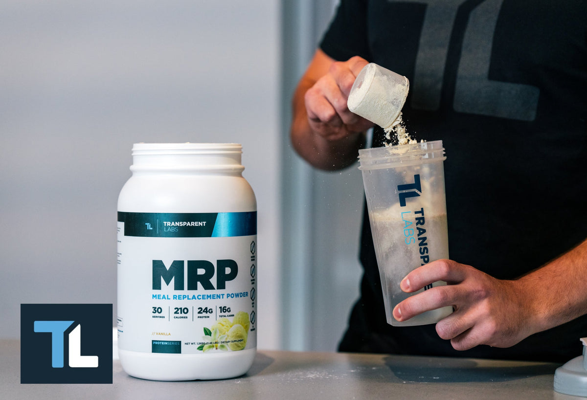 Person preparing a vanilla meal replacement powder shake with Transparent Labs tub and shaker